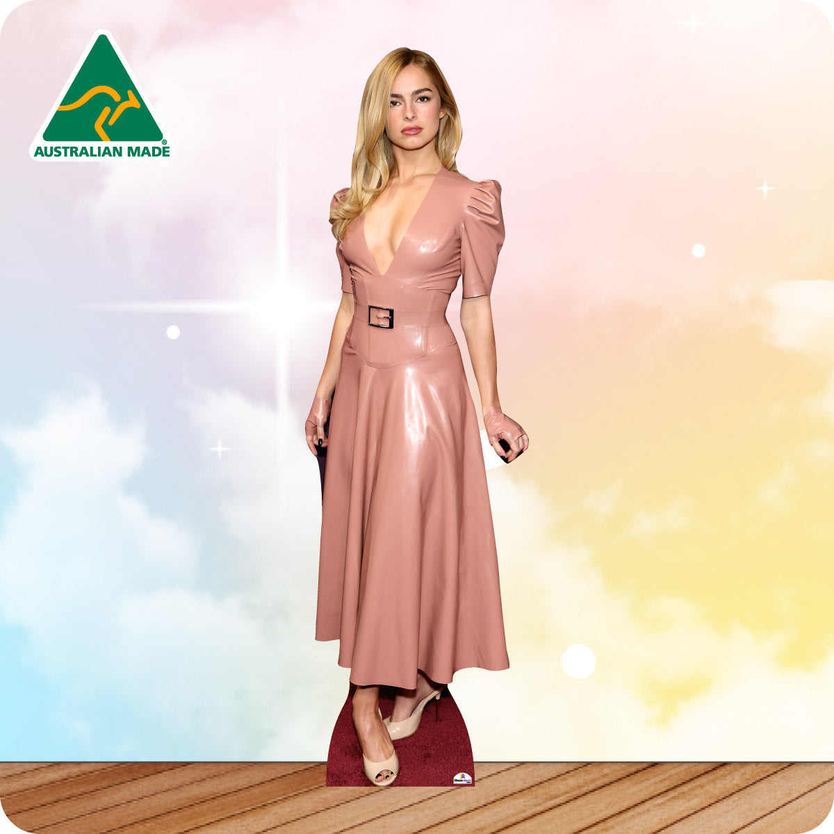 Woman in a pink dress standing on a wooden floor with a colorful background and 'Australian Made' logo.