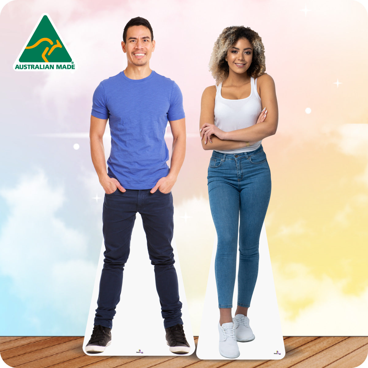 Cardboard cutouts of a man and woman standing on a wooden floor with a colorful background.