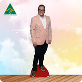 Cardboard cutout of a person in a pink blazer on a red platform with a blurred background