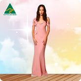 Woman wearing a pink dress with an 'Australian Made' logo in the corner.