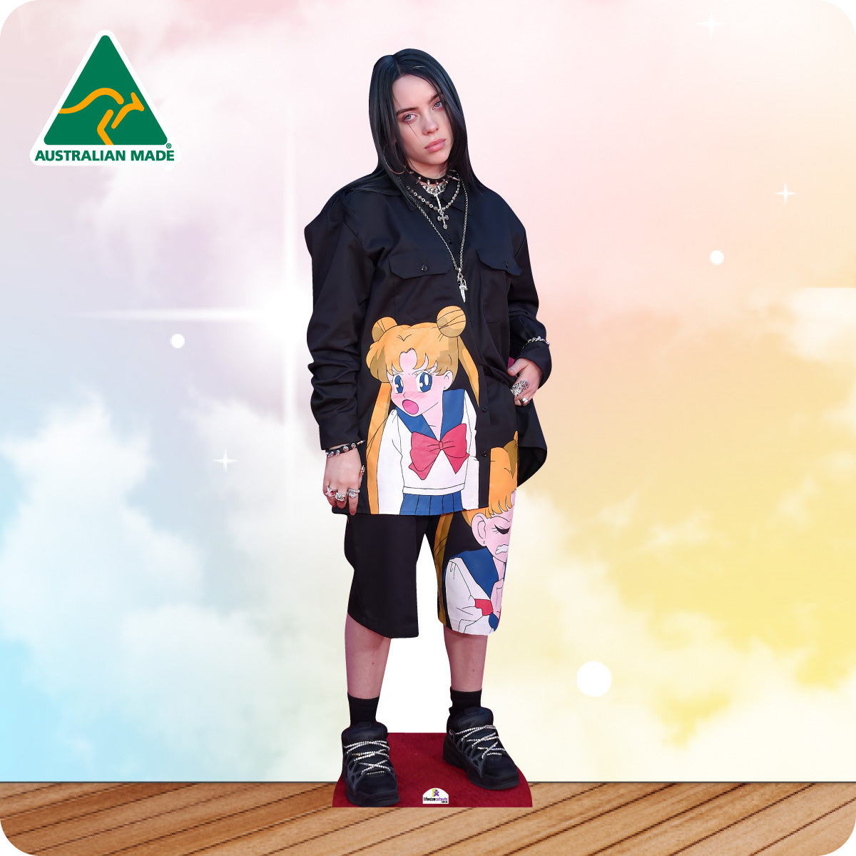 Cardboard cutout of a person wearing a colorful outfit with anime design on a gradient background.