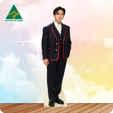 Person wearing a formal black suit with red accents on a colorful background, featuring 'Australian Made' logo.