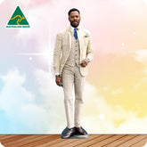 Cardboard cutout of a man in a cream colored suit with 'Australian Made' logo on a colorful background