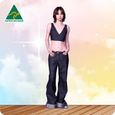 Woman wearing a black top and blue jeans on a colorful background with 'Australian Made' logo.