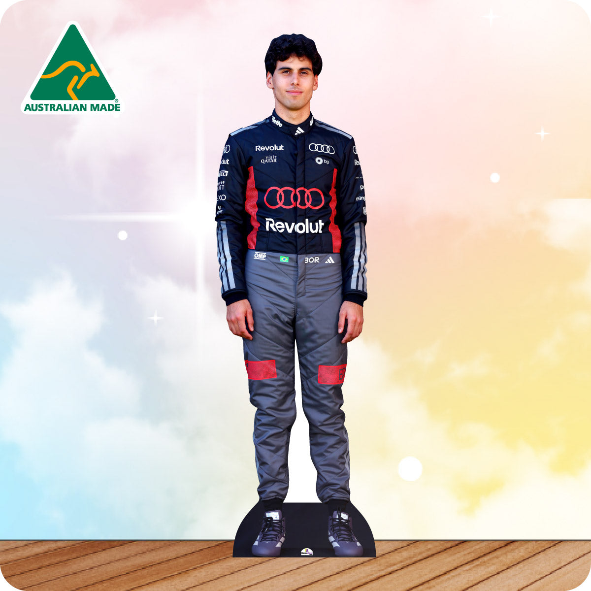 Cardboard cutout of a person in a racing suit with 'Revolut' branding on a gradient background.