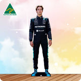 Person wearing a Formula 1 racing suit with visible branding on a gradient background
