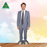 Man wearing a gray suit with a tie against a colorful background with 'Australian Made' logo.