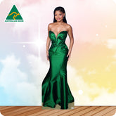 Woman in a green evening gown against a colorful gradient background with 'Australian Made' logo.