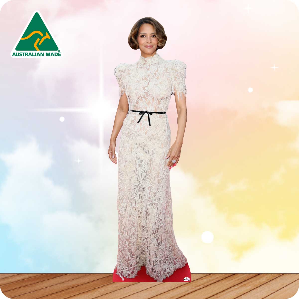 Woman in a lace dress standing on a wooden floor with a blurred background, Australian Made logo visible.