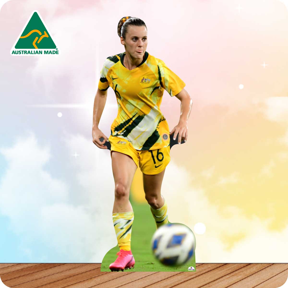 Soccer player in a yellow uniform kicking a ball with 'Australian Made' logo in the corner.