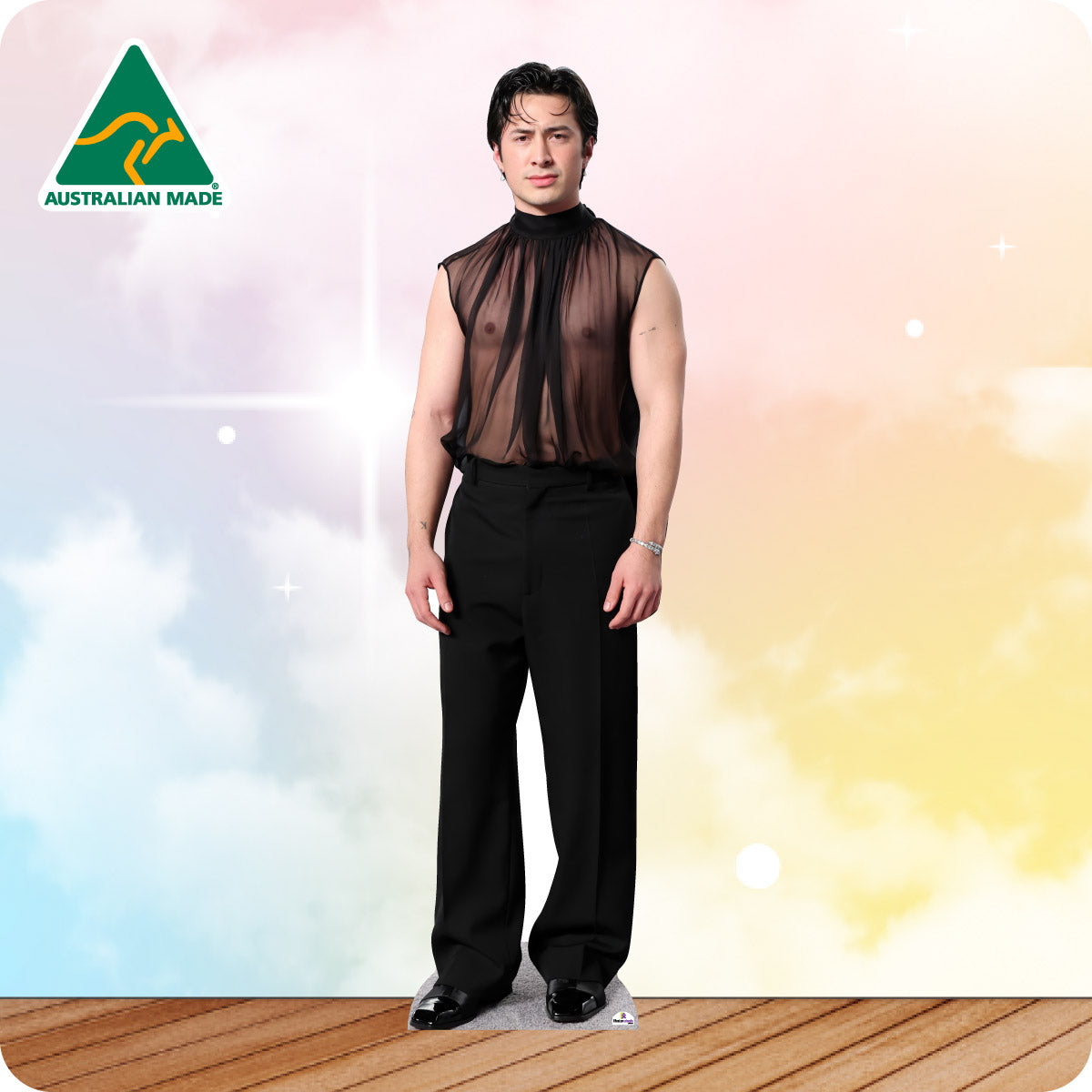Hudson Williams In a black transparent shirt and black pants.