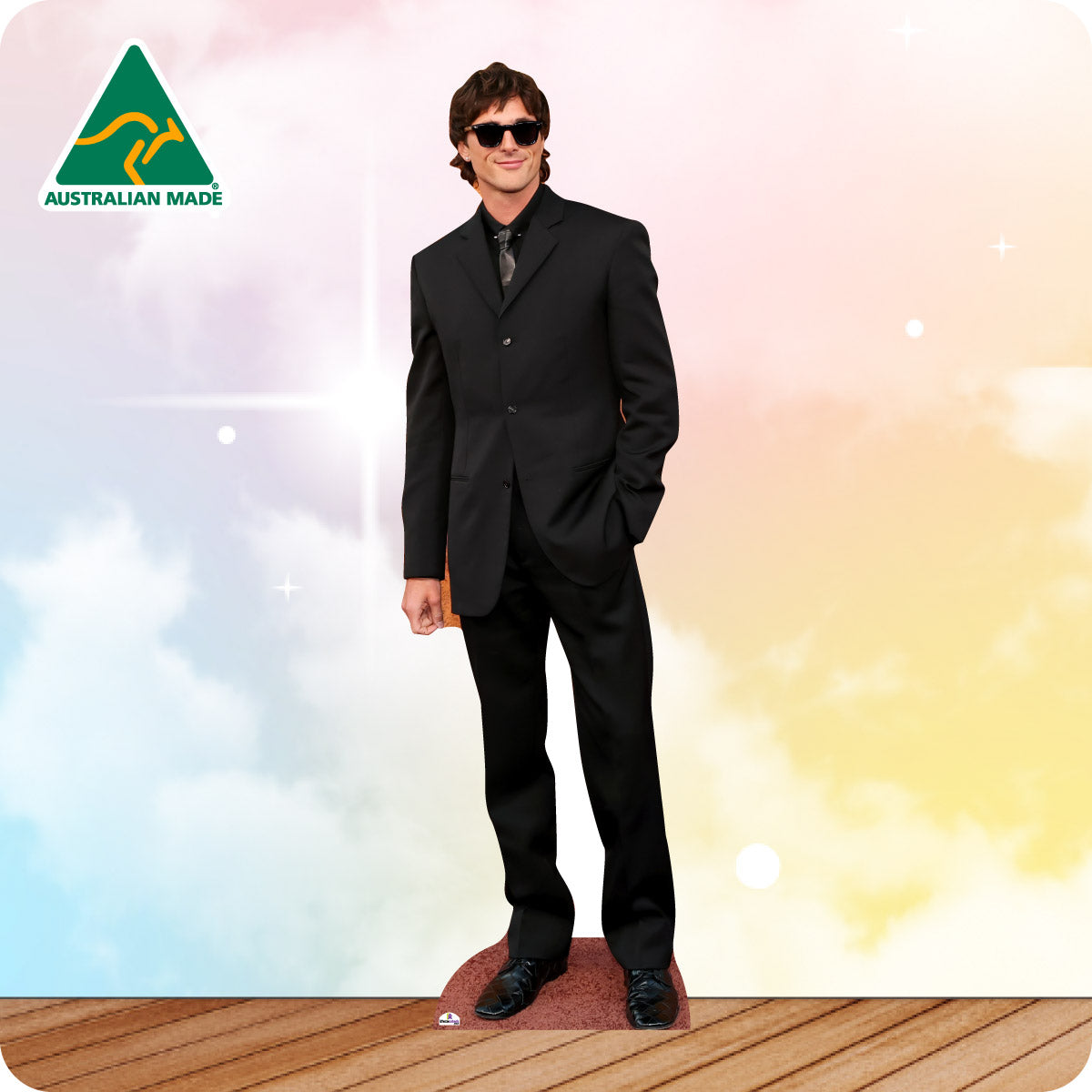 Man wearing a black suit and sunglasses on a colorful background with 'Australian Made' logo.