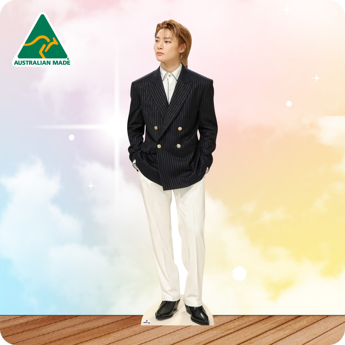 Person wearing a black suit with a white shirt on a colorful background with 'Australian Made' logo.