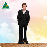 Man in a black suit standing on a wooden floor with a colorful background and Australian Made logo.