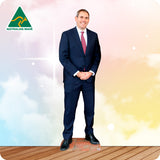 Man in a suit standing in front of a colorful background with 'Australian Made' logo.