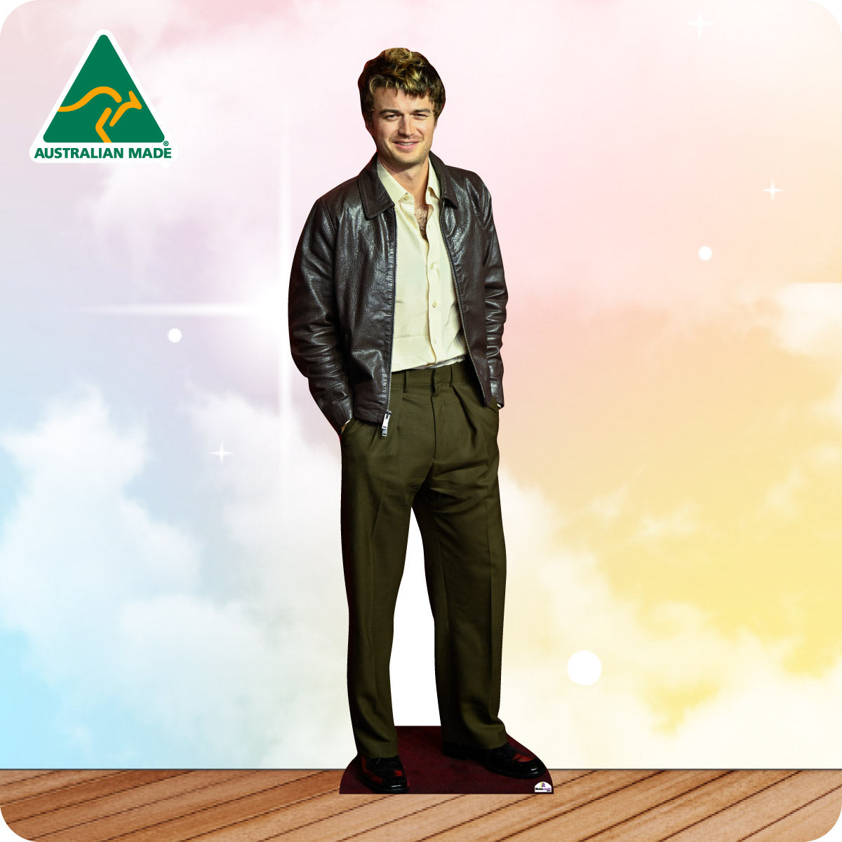 Man wearing a leather jacket and green pants standing on a wooden floor with a colorful background and 'Australian Made' logo.