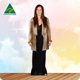 Woman wearing a beige jacket over a black dress with an Australian Made logo on a colorful background.