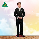 Man wearing a black suit with a white shirt on a colorful background, featuring 'Australian Made' logo.