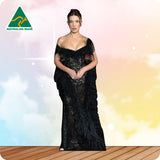 Woman wearing a black lace dress with a blurred background and 'Australian Made' logo.