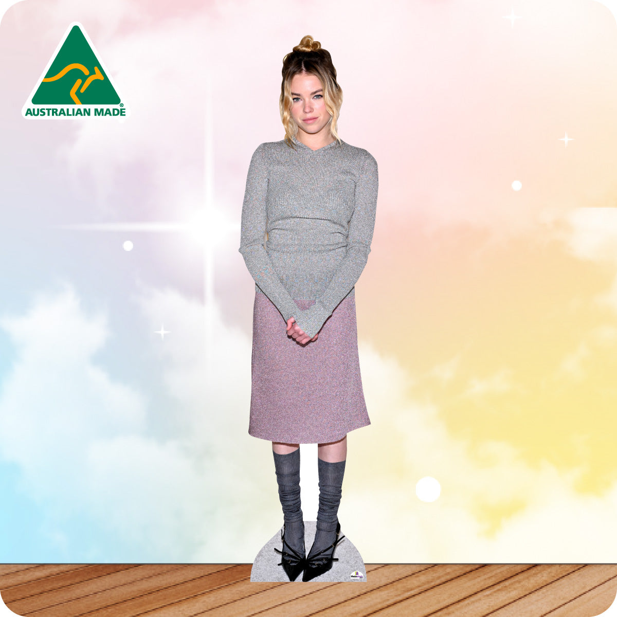 Cardboard cutout of a person wearing a gray sweater and pink skirt with 'Australian Made' logo in the corner.