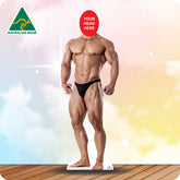 Cardboard standee of a muscular man with a red circle for head replacement on a colorful background, Australian Made logo visible.
