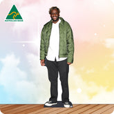Man wearing a green jacket with 'Australian Made' logo on a colorful background