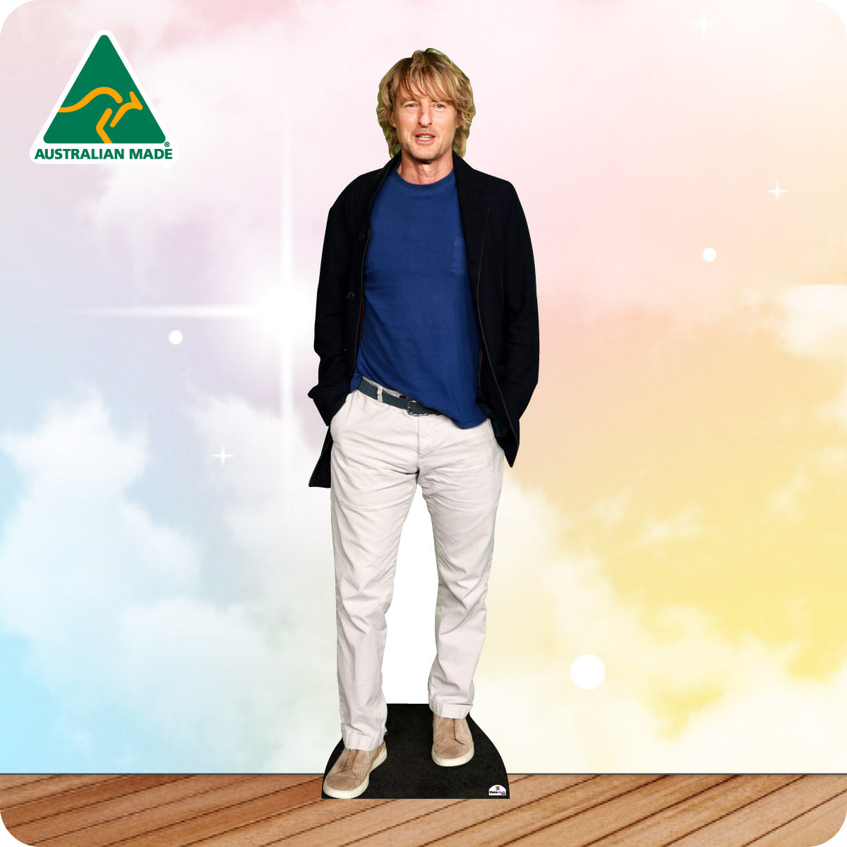 Cardboard cutout of a person wearing a blue shirt and white pants with an Australian Made logo on a colorful background.