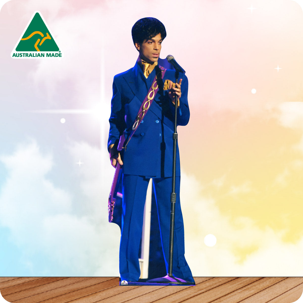 Person in a blue suit with a microphone on a wooden floor and colorful background, Australian Made logo visible.