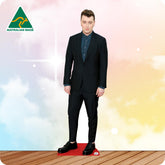 Life-size Sam Smith cutout wearing a black tuxedo, white shirt, black bow tie and dress shoes.