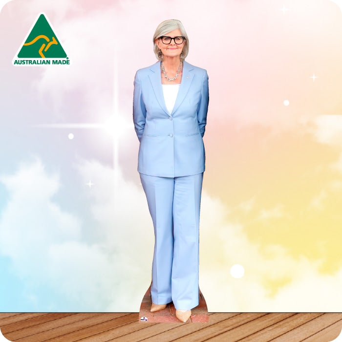 Woman in a light blue suit standing on a wooden deck with a gradient background, Australian Made logo visible.