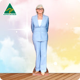 Woman in a light blue suit standing on a wooden deck with a gradient background, Australian Made logo visible.