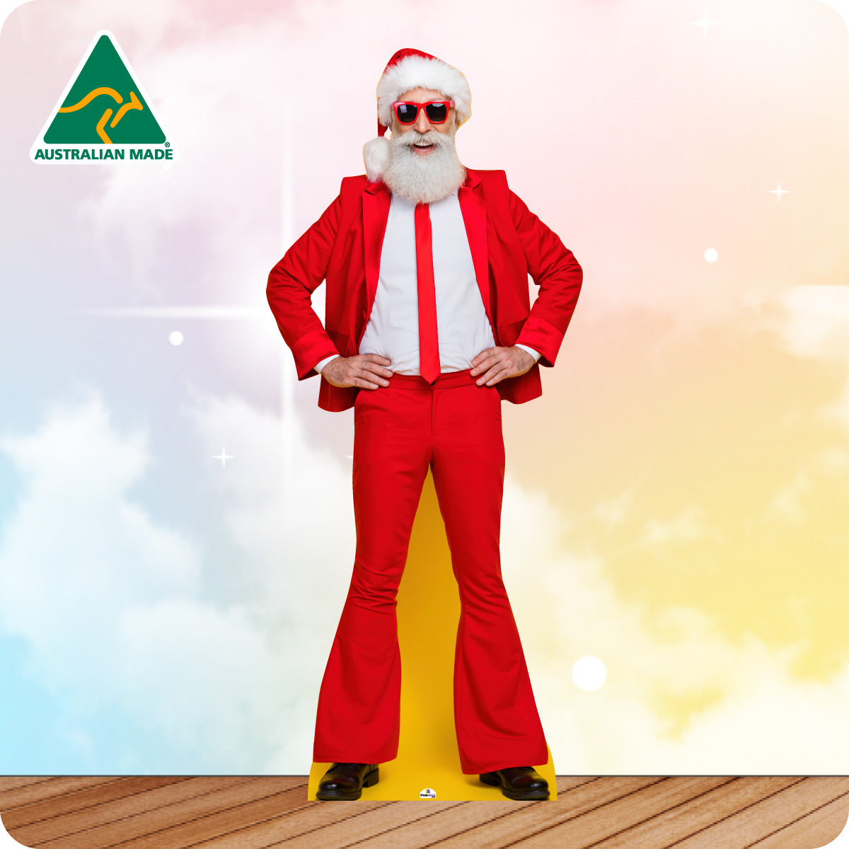 Cardboard cutout of a Santa Claus in a modern outfit with sunglasses on a gradient background.