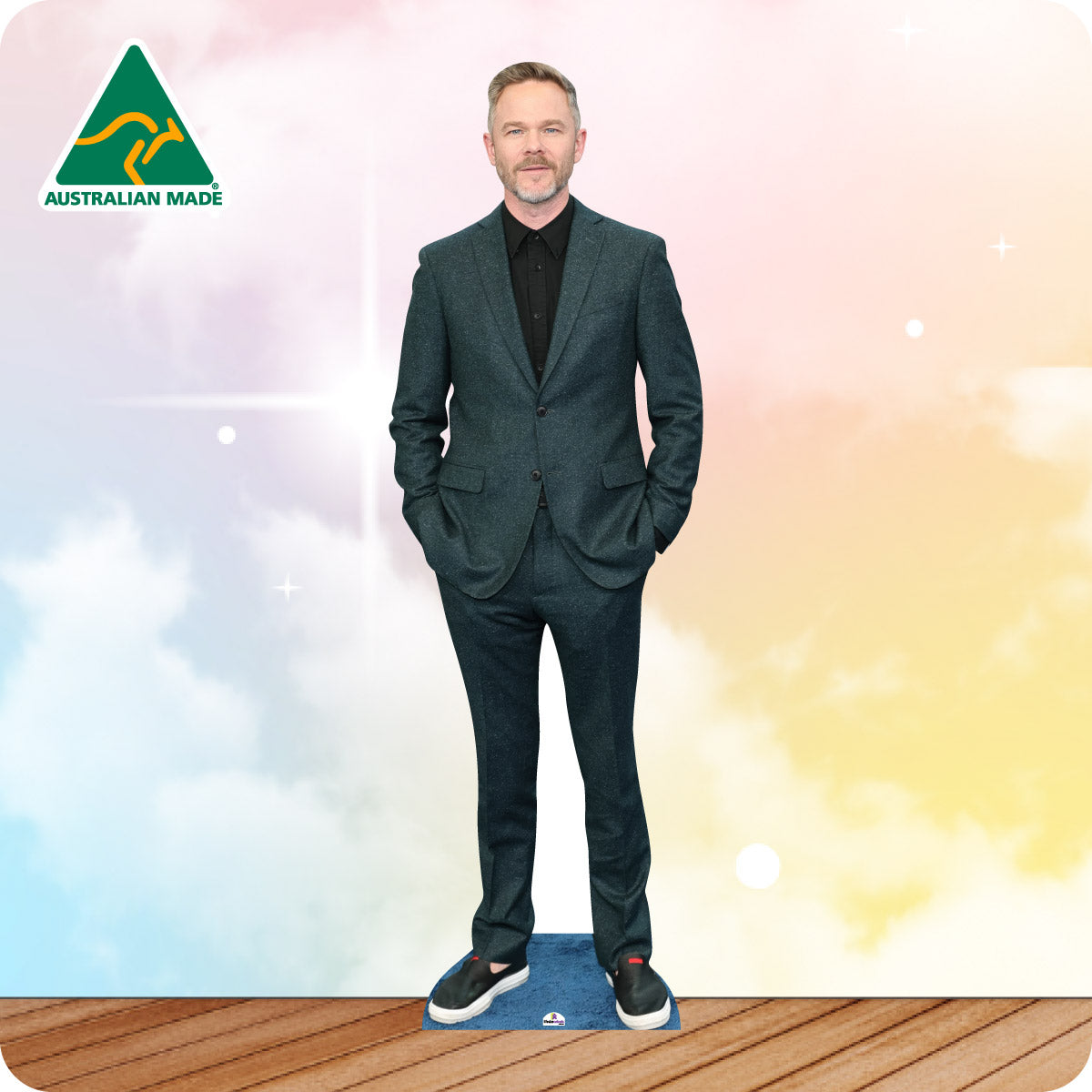 Cardboard cutout of a person in a grey suit with 'Australian Made' logo on a colorful background