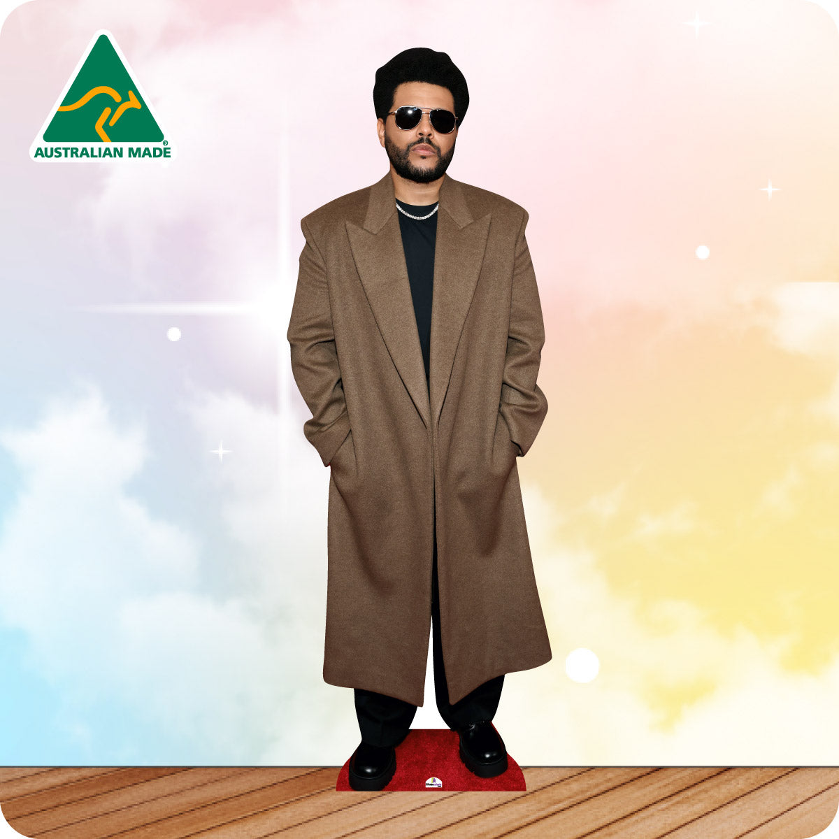 Cardboard cutout of a person wearing a long coat with 'Australian Made' logo in the corner.