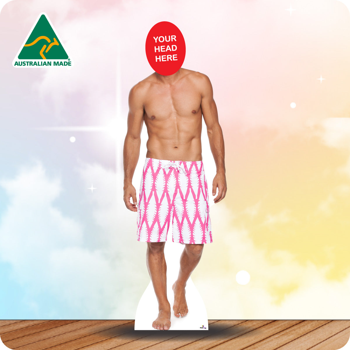 Cardboard standee of a man wearing pink swim trunks with 'Your Head Here' placeholder on a colorful background.