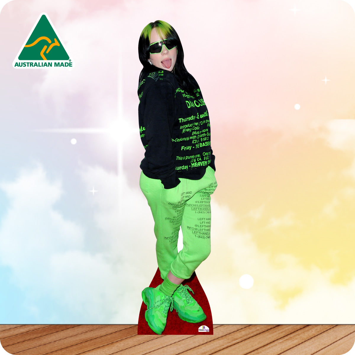 Cardboard cutout of a person wearing a black hoodie with green text and bright green pants on a colorful background.