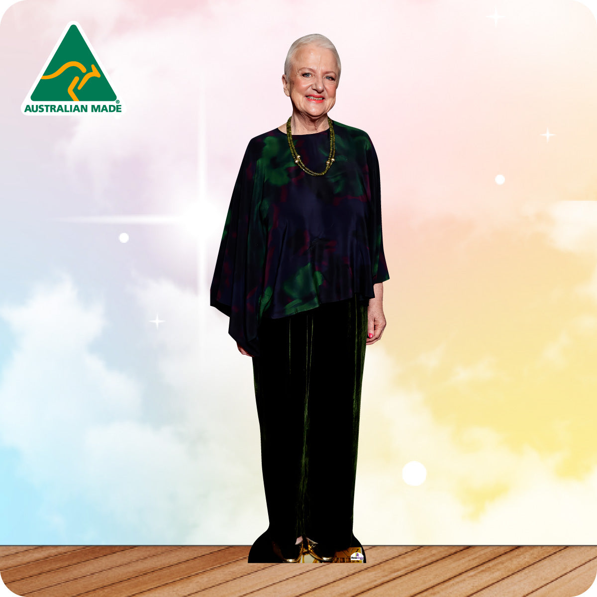 Woman in a dark outfit standing on a wooden floor with a colorful background and 'Australian Made' logo.
