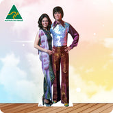 Life-size Donny and Marie Osmond cutout wearing elegant black stage outfits with matching formal shoes.