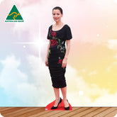 Life-size Tina Arena cutout wearing a long black dress with sheer sleeves and black high heels.