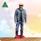 Life-size Toby Keith cutout wearing a black cowboy hat, black shirt, blue jeans and brown boots.