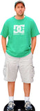 Man wearing a green t-shirt and gray shorts standing on a black platform.