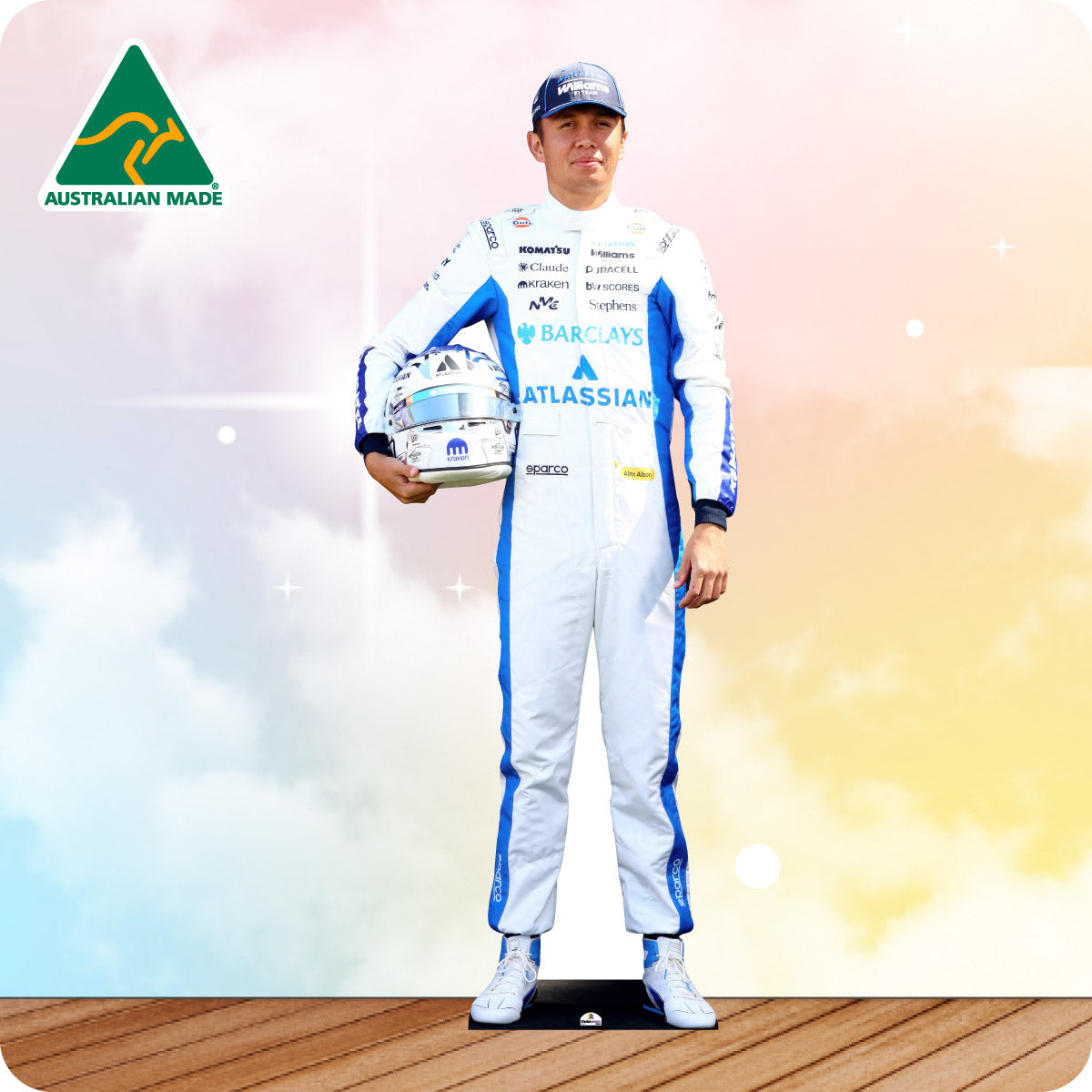 Person in racing suit holding trophies with 'Australian Made' logo in the corner