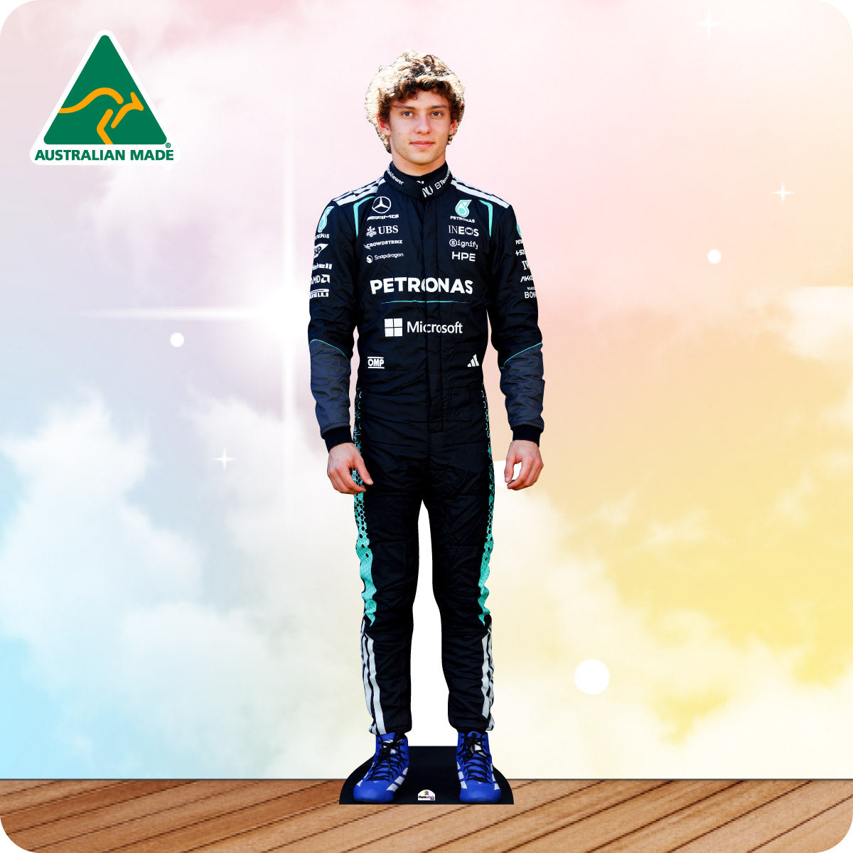 Person wearing a Formula 1 racing suit with Petronas and Microsoft branding on a colorful background.