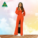 Woman in a red outfit holding a microphone on a stage with 'Australian Made' logo.
