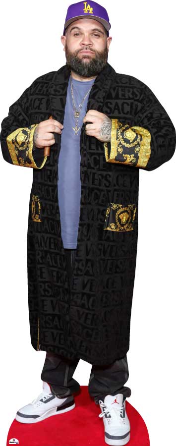 Person wearing a black coat with gold accents and a purple cap on a white background
