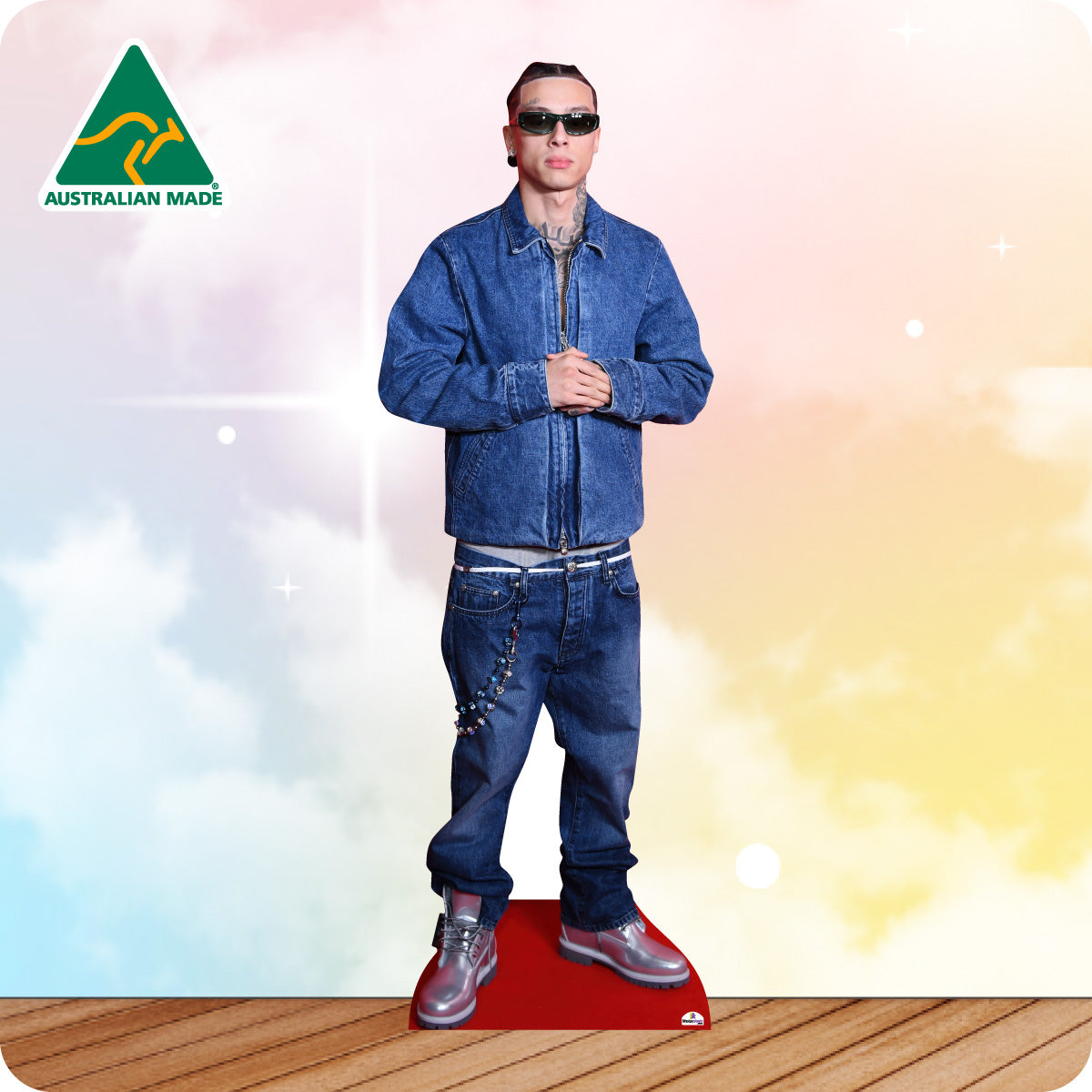Cardboard standee of a person wearing a blue denim outfit with sunglasses on a colorful background.