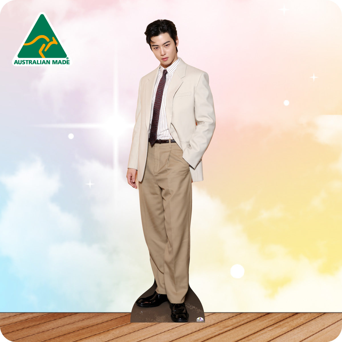 Man wearing a beige suit with a colorful gradient background and 'Australian Made' logo.