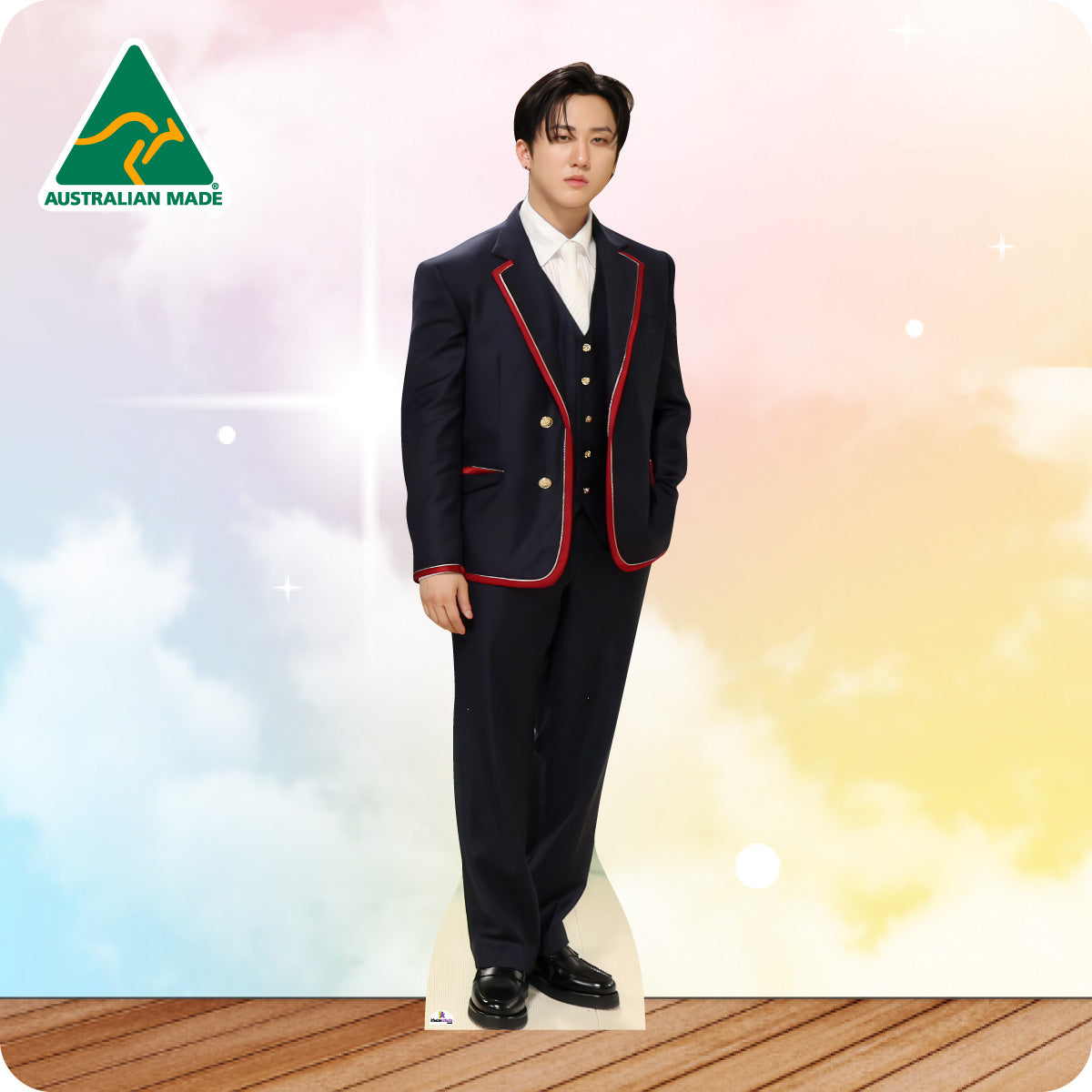 Person wearing a formal black suit with red accents on a colorful background, featuring 'Australian Made' logo.