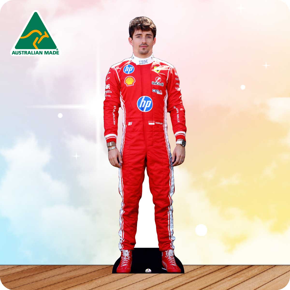 Cardboard cutout of a person in a red racing suit with brand logos on a wooden floor.
