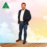 Man in formal attire standing on a wooden platform with 'Australian Made' logo in the corner.